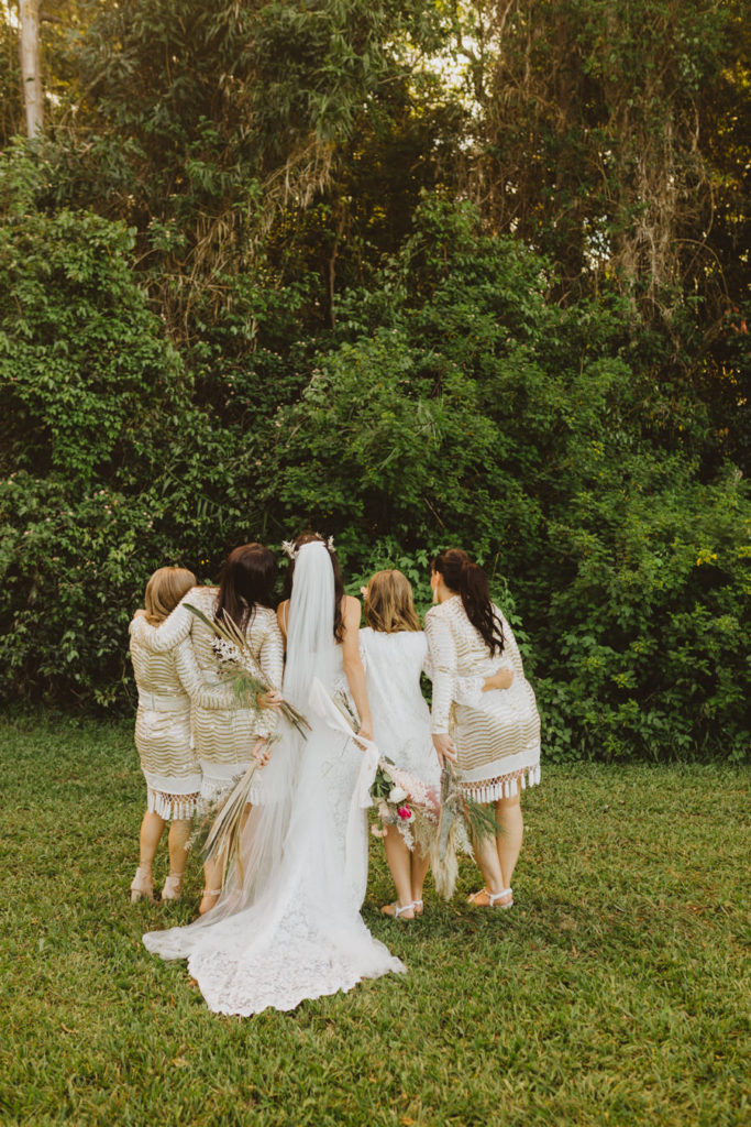 bridemaids in gold boho dresses with fringe
