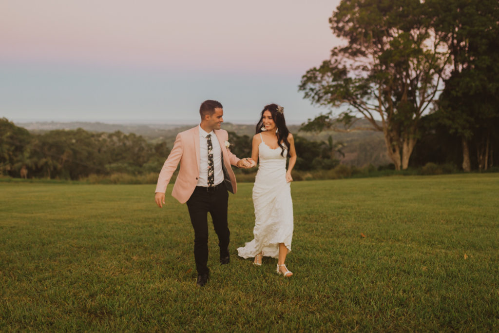 bride and groom running through fields at sunset during their wedding at Ardeena in NSW Australia