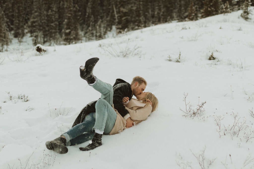 couple rolling around in the snow