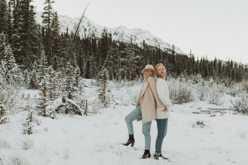 Winter engagement session in the mountains, couple wearing neutral colours and coordinating outfit