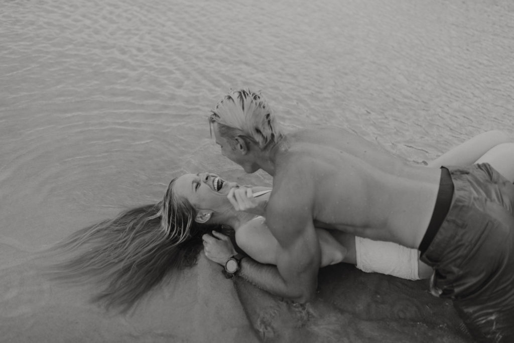black and white couple photography in ocean