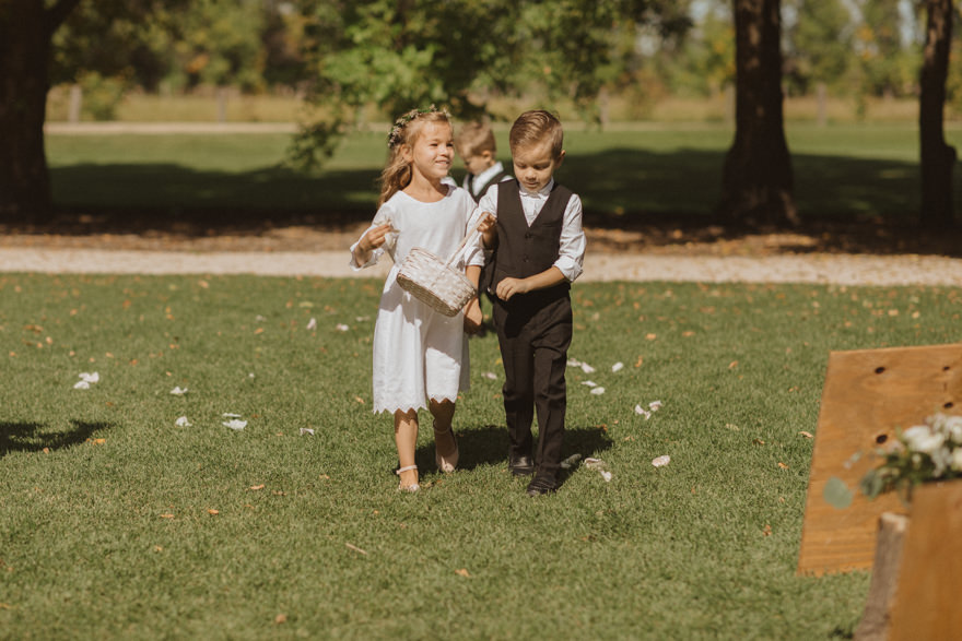 flower girl and flower boy walking down aisle at Ashgrove Acres
