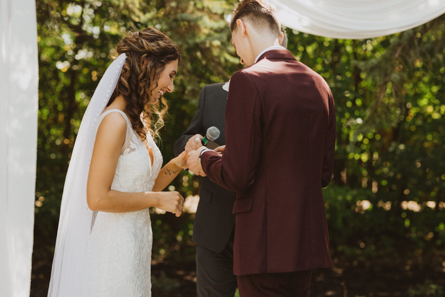 ring exchange during wedding ceremony at Ashgrove Acres