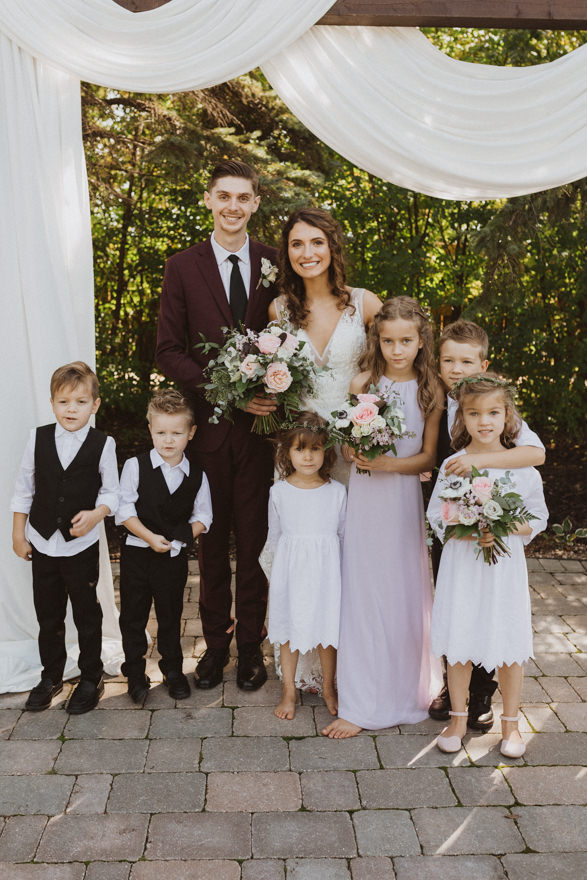 bride and groom with all their little cousins 