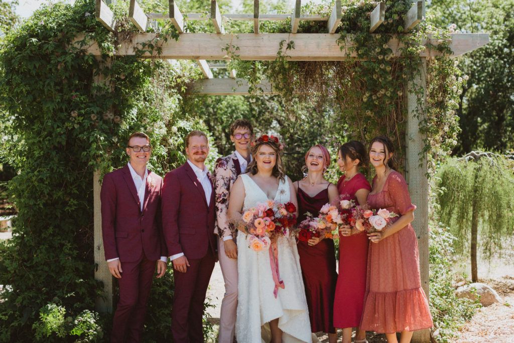 bridal party portraits, wedding colours are pink, maroon, and rust orange