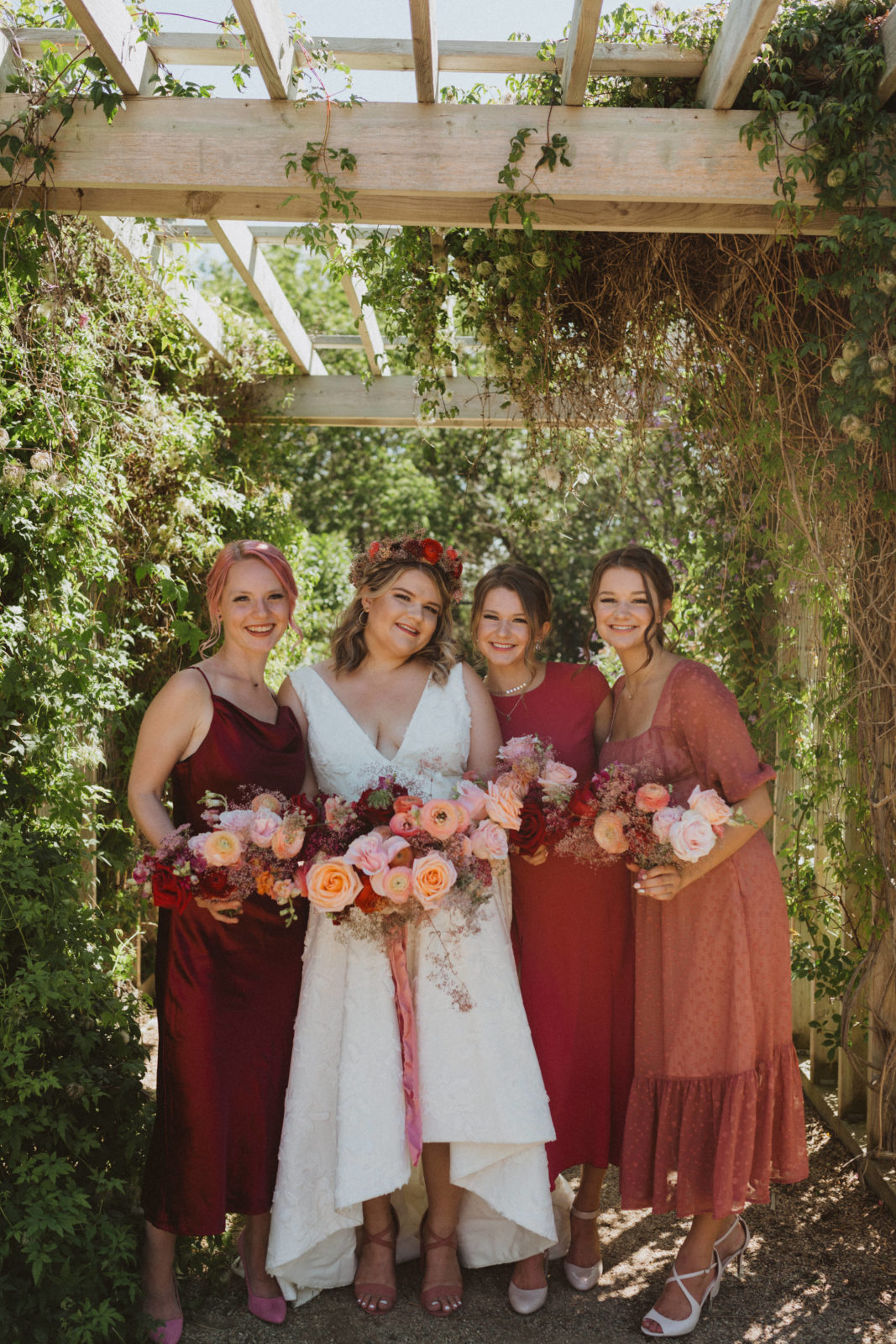 bridesmaids wearing colourful mismatched dresses