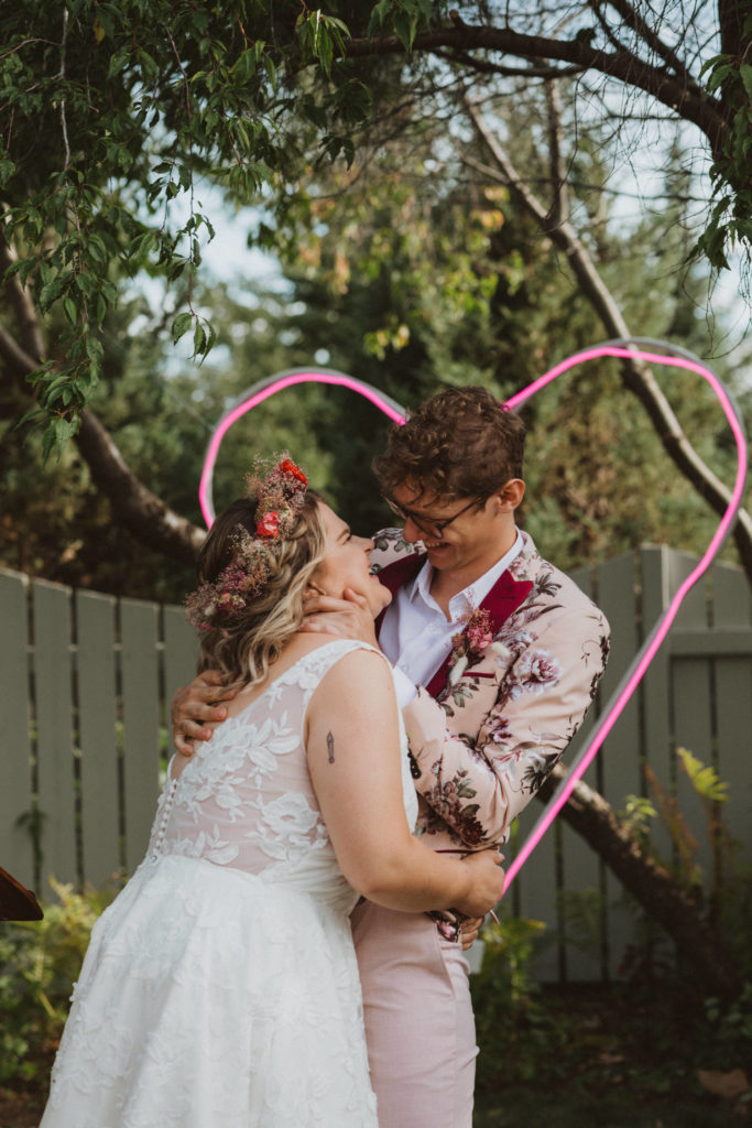 colourful, chic backyard wedding with neon heart decor
