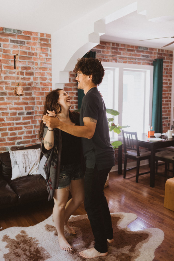 in-home session, couple dancing in their living room together