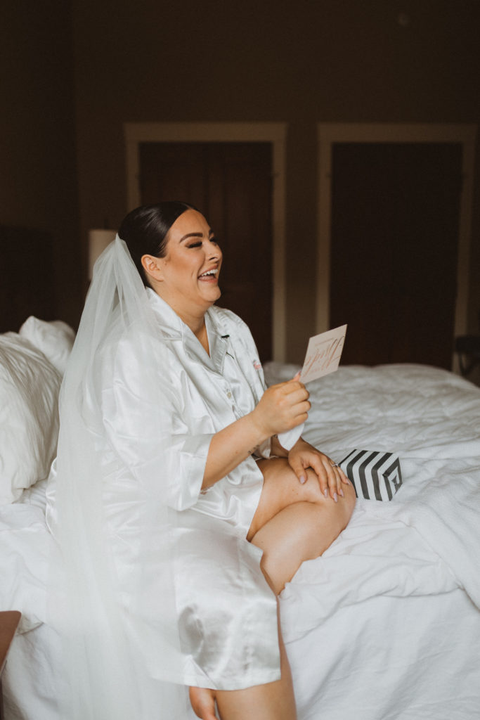 bride reads letter from groom while getting ready before her elopement. Very emotional getting ready ideas for your elopement day. Getting ready pictures. 