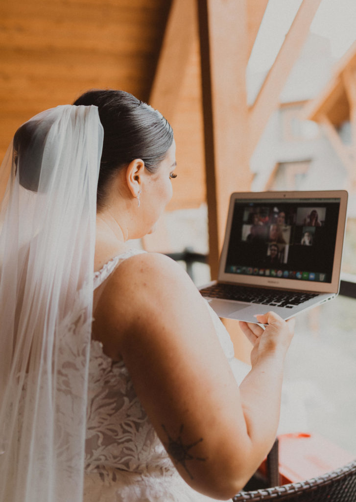 Bride facetimes her bridesmaids who were not present at her elopement which is a great way to include your loved ones in your elopement day when they aren't there.