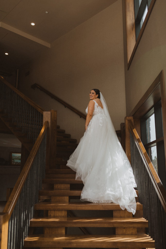 Bride walking up the stairs at the Malcolm Hotel in Canmore, Alberta before walking down the aisle.