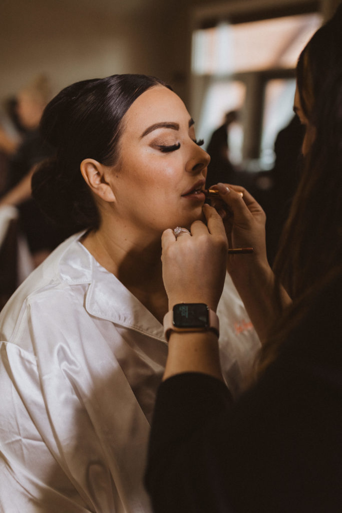 bride getting ready with Nikole D Beauty, a Canmore makeup artist who does on location styling.