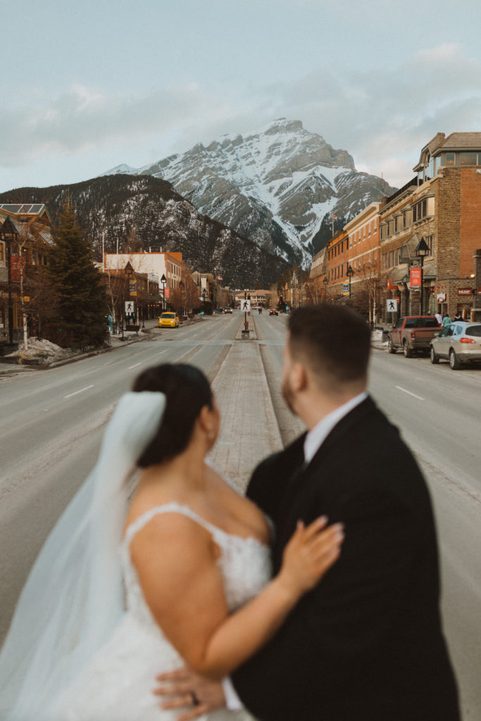 Town of Banff wedding portraits looking at the mountains. Images by Liv Hettinga Photography an Alberta Elopement photographer.