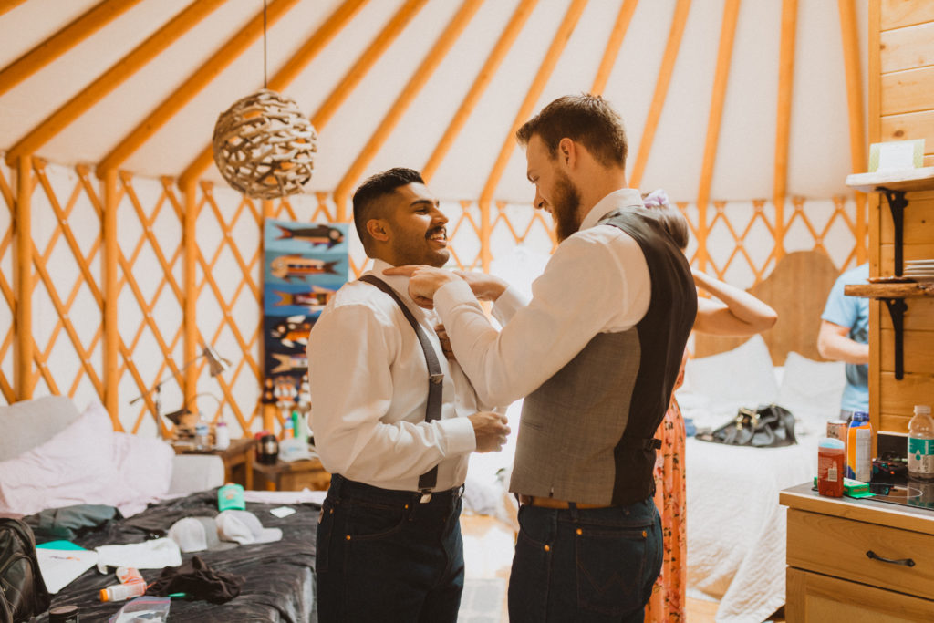 Groom and best man getting ready together. Getting ready photos at Flora Bora inside a yurt.