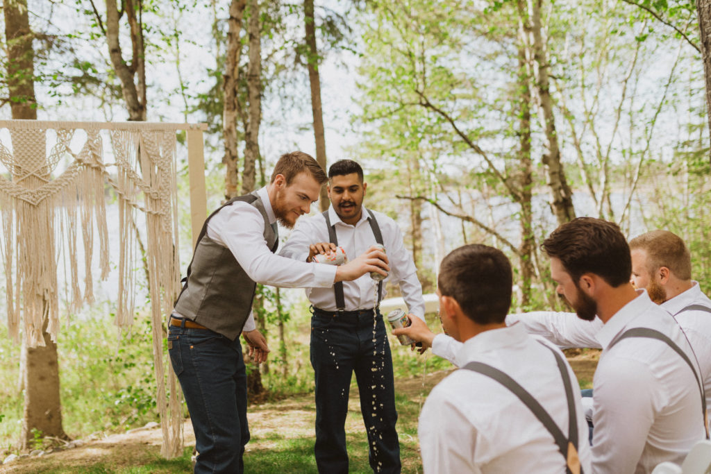 Groom and groomsmen have a beer to celebrate him getting married during ceremony