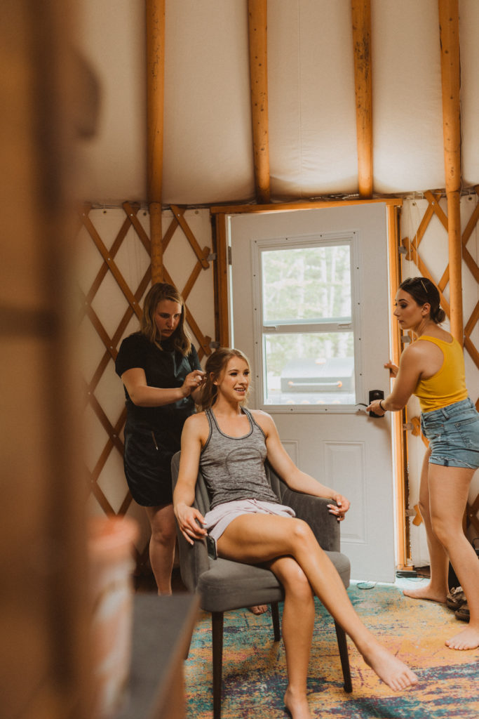 Bride getting hair done by Hairstyles by Jess inside a yurt on her elopement day. Getting ready photos. Yurt elopement. Intimate wedding. 