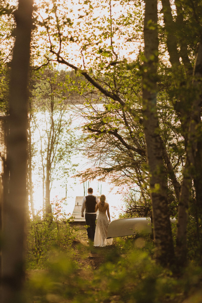 Flora Bora yurt elopement in the forest. Bride and Groom wedding portraits. Posing ideas. Couple photos by Liv Hettinga Photography a Saskatchewan elopement photographer. Couple walking out to the dock.