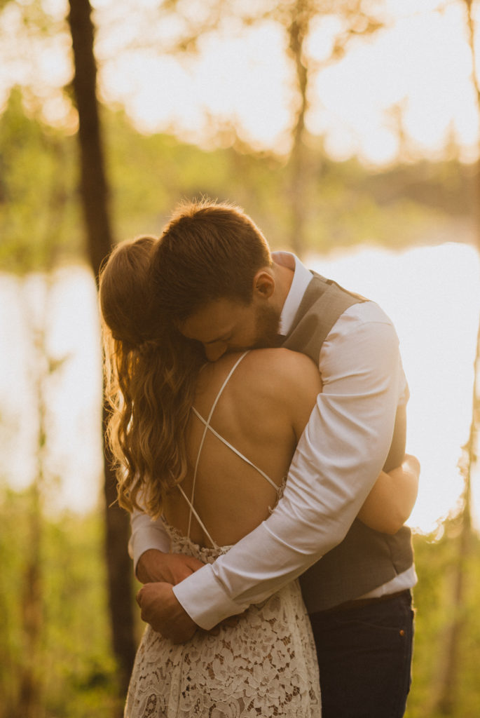 Flora Bora yurt elopement in the forest. Bride and Groom wedding portraits. Posing ideas. Couple photos by Liv Hettinga Photography a Saskatchewan elopement photographer. Bride and Groom hugging.