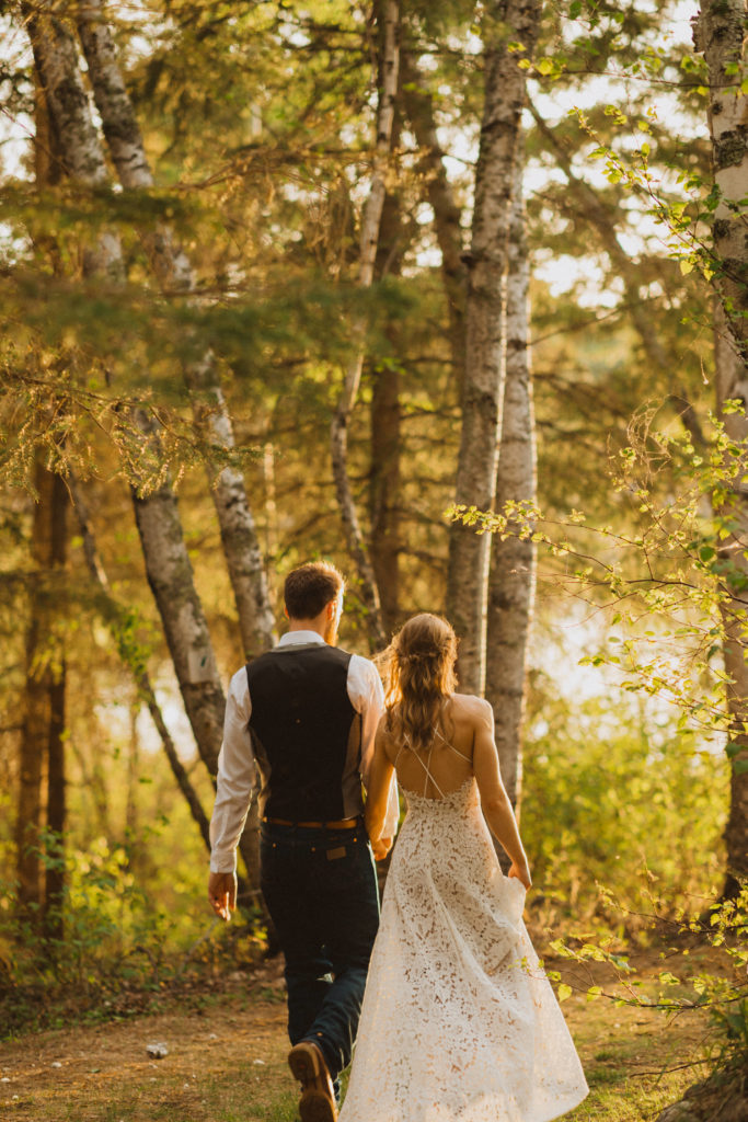 Flora Bora yurt elopement in the forest. Bride and Groom wedding portraits. Posing ideas. Couple photos by Liv Hettinga Photography a Saskatchewan elopement photographer.  Sunset portraits walking through the trees.