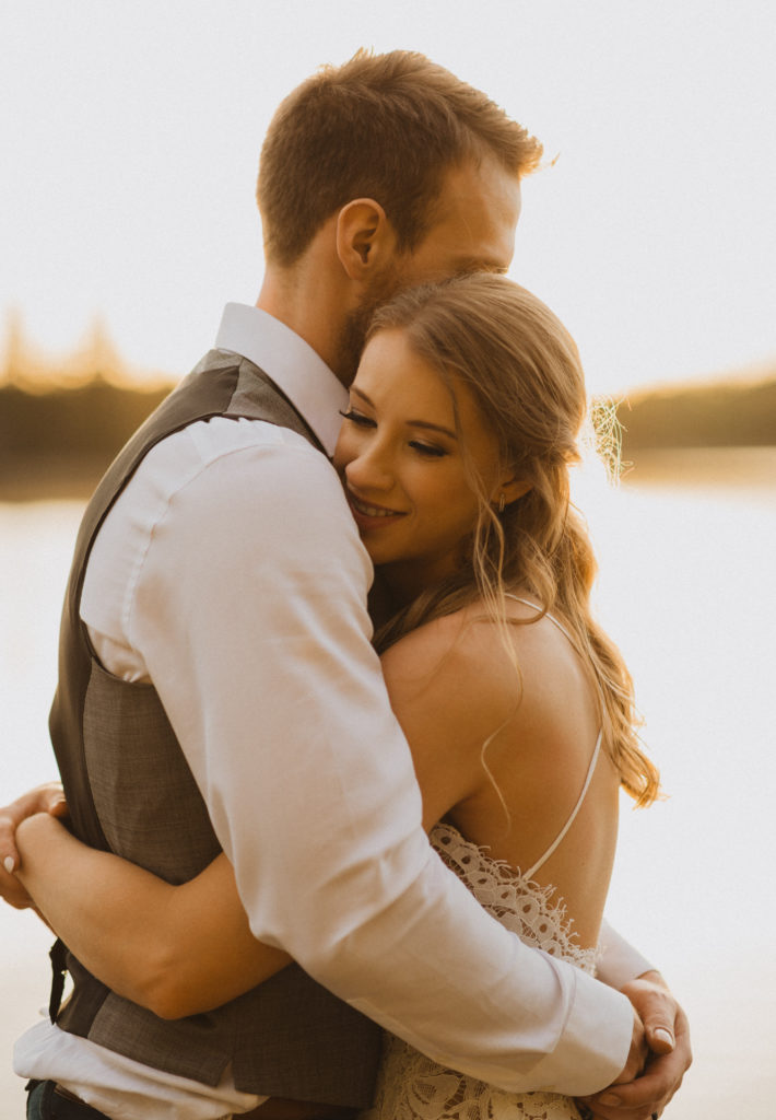 Flora Bora yurt elopement in the forest. Bride and Groom wedding portraits. Posing ideas. Couple photos by Liv Hettinga Photography a Saskatchewan elopement photographer. Bride and groom hugging, sunset portraits.