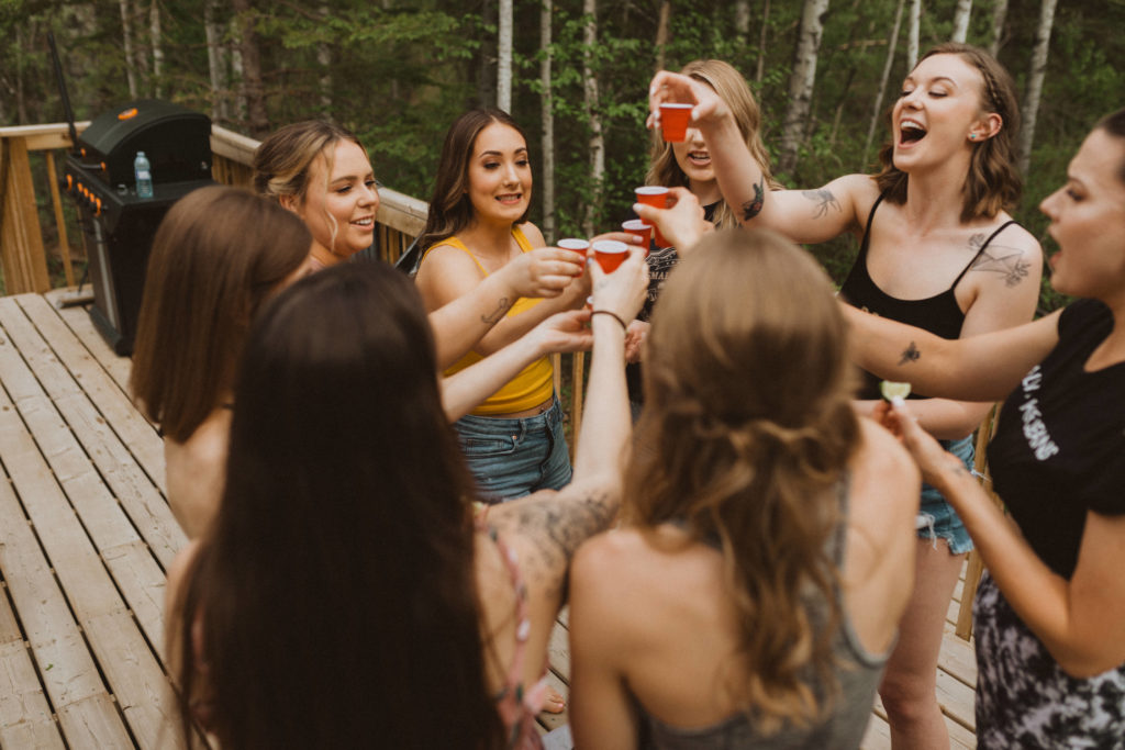 Bride celebrates with shots and her close friends before intimate wedding ceremony.