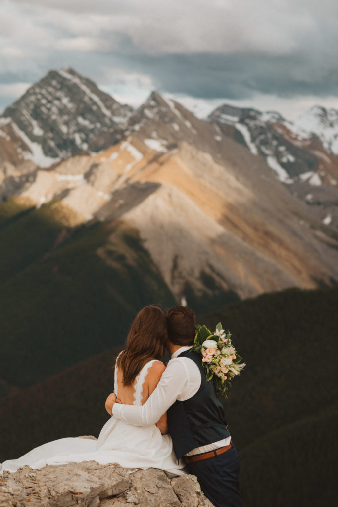 bride and groom enjoying the views in Jasper National Park on their mountaintop elopement day