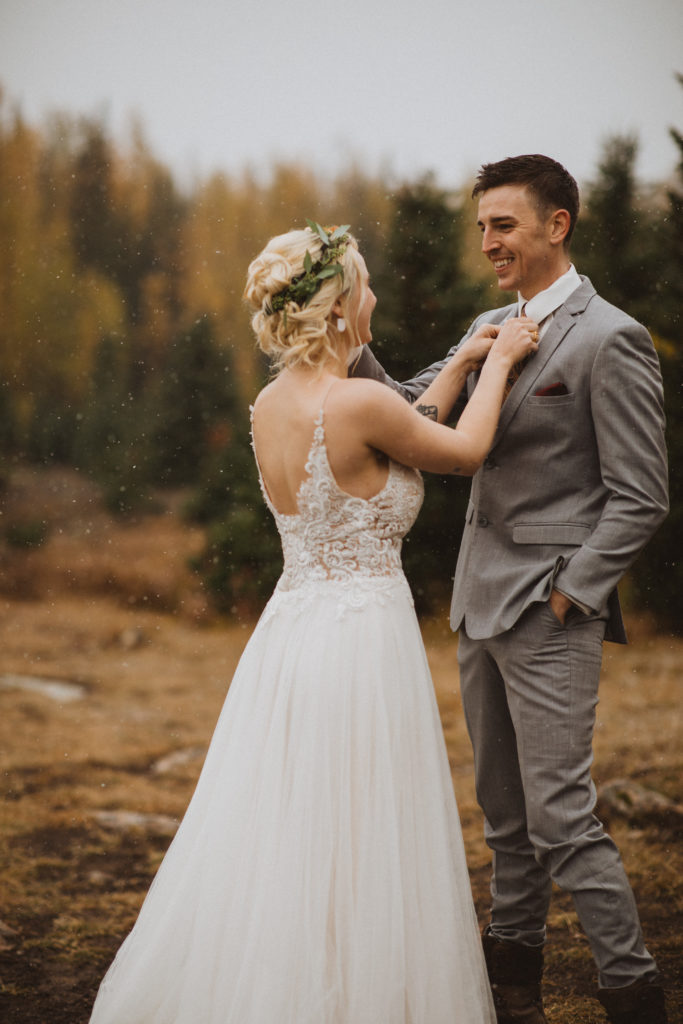 couple changes into their wedding attire partway up the hike