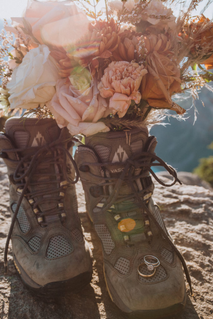 hiking boots and wedding bouquet and rings