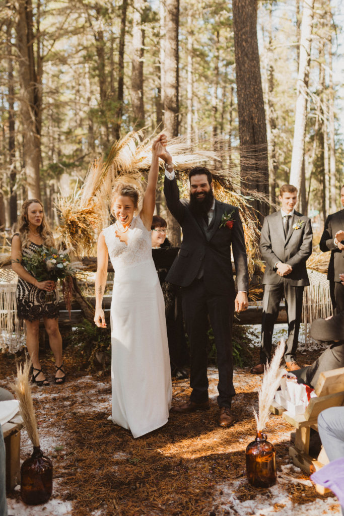 couple have a small wedding with family in the woods