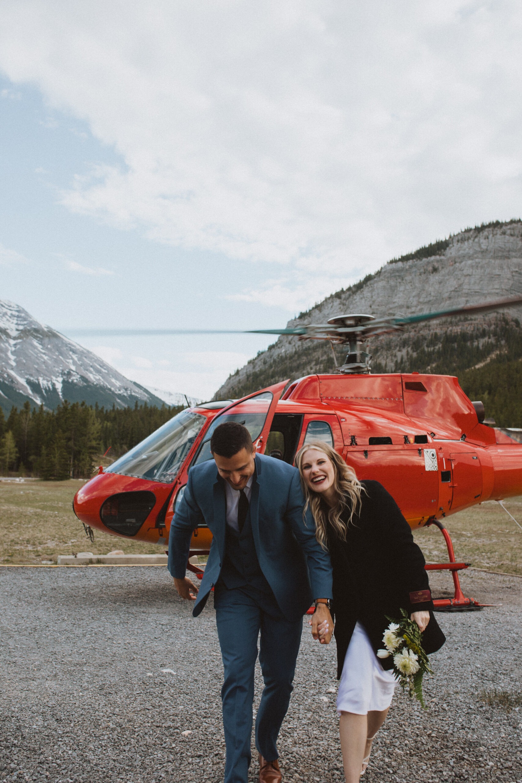 couple takes helicopter tour over banff with alpine helicopters
