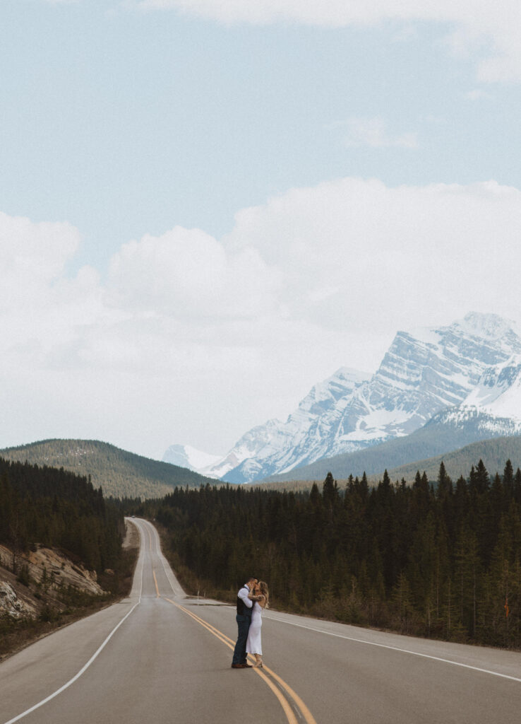 couple taking pictures on the Icefields Parkway Highway
