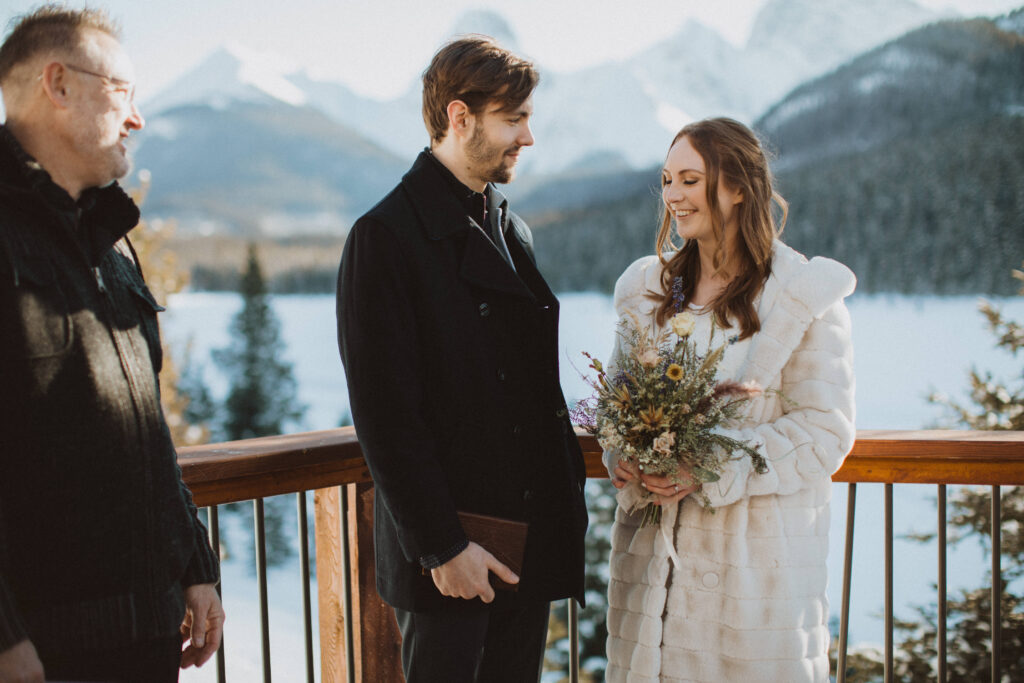 couple has an intimate wedding at Mount Engadine Lodge in Kananaskis Alberta, ceremony on the back deck
