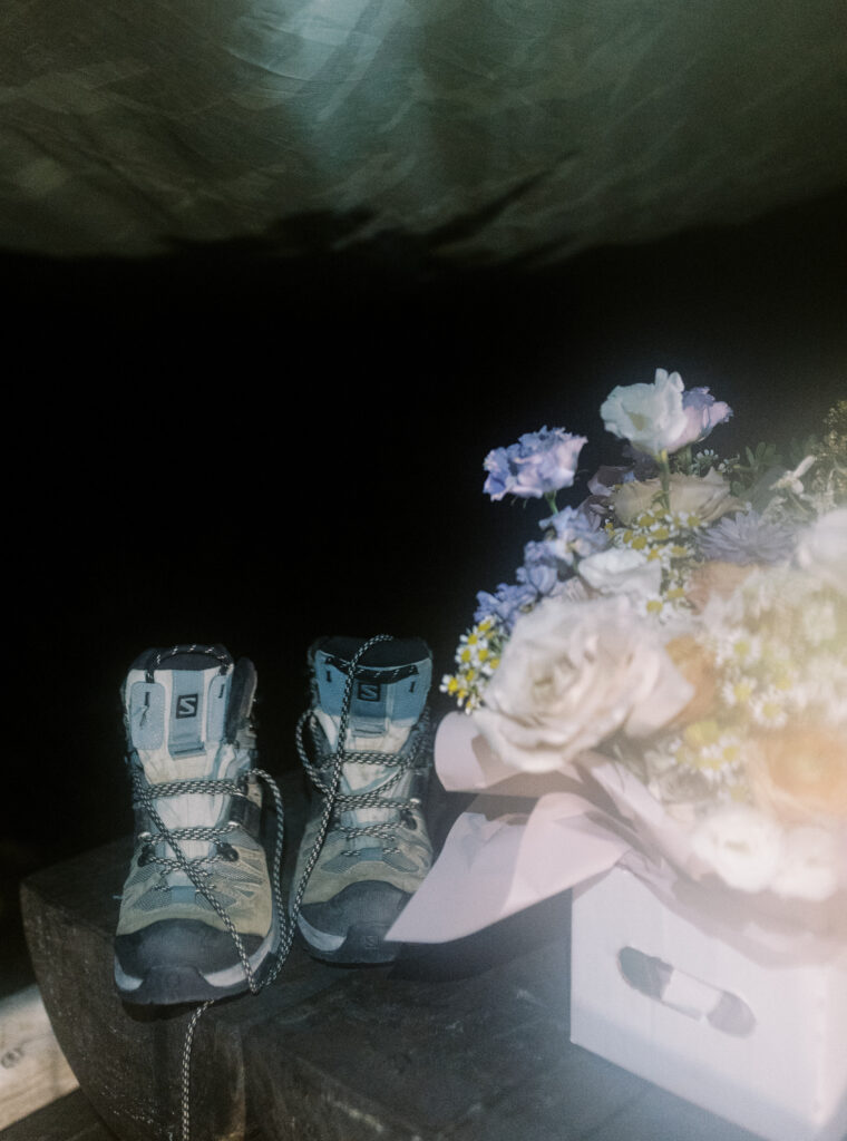 hiking boots and bouquet packed for sunrise hike at backcountry elopement in Banff